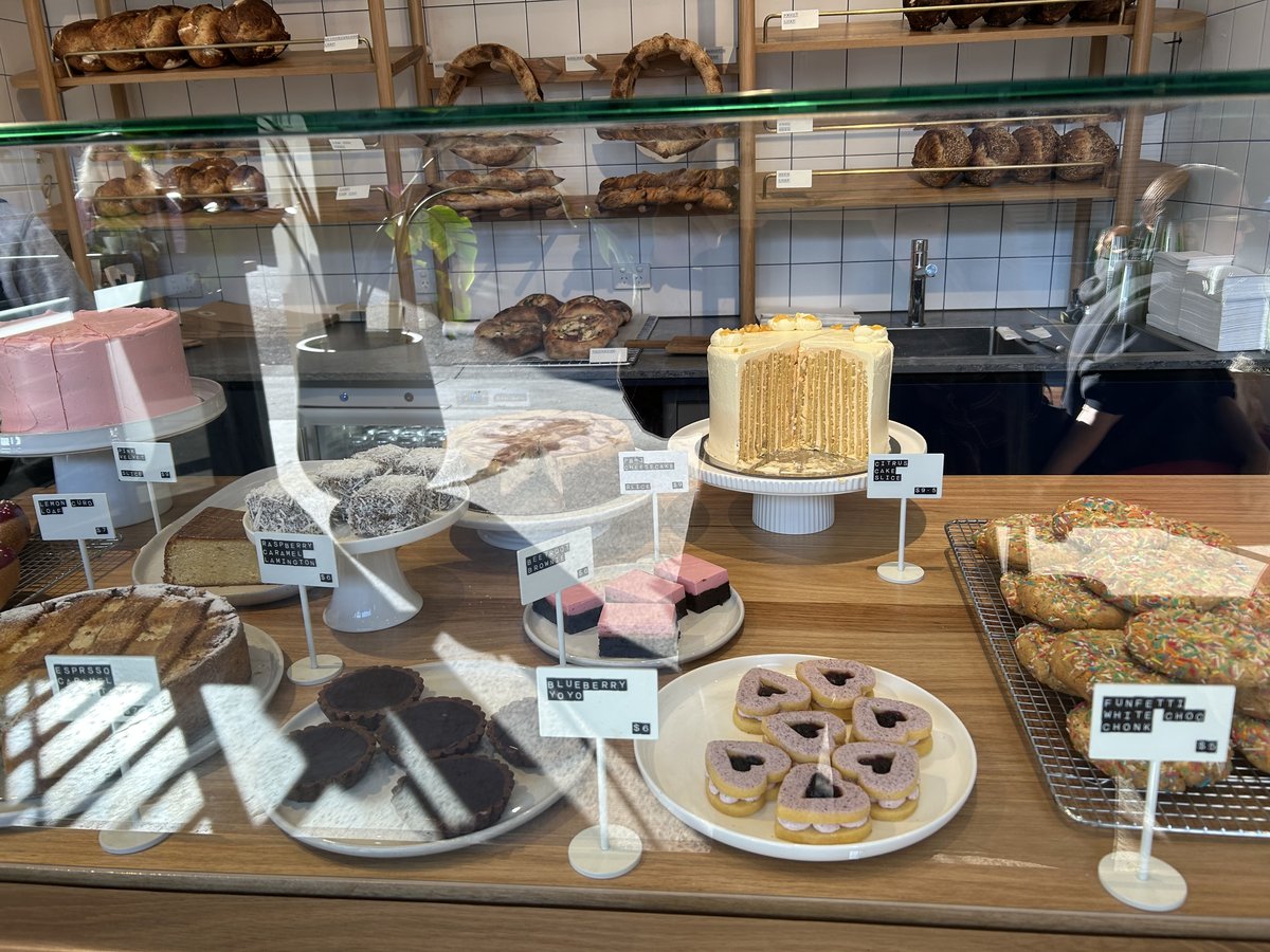 Pastry display case with cakes, lamingtons and sprinkle cookies at Baker of Things
