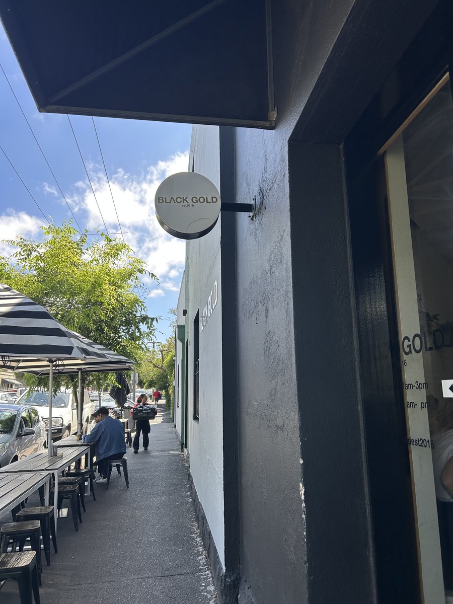 Black Gold round sign hanging above the laneway entrance, established 2016