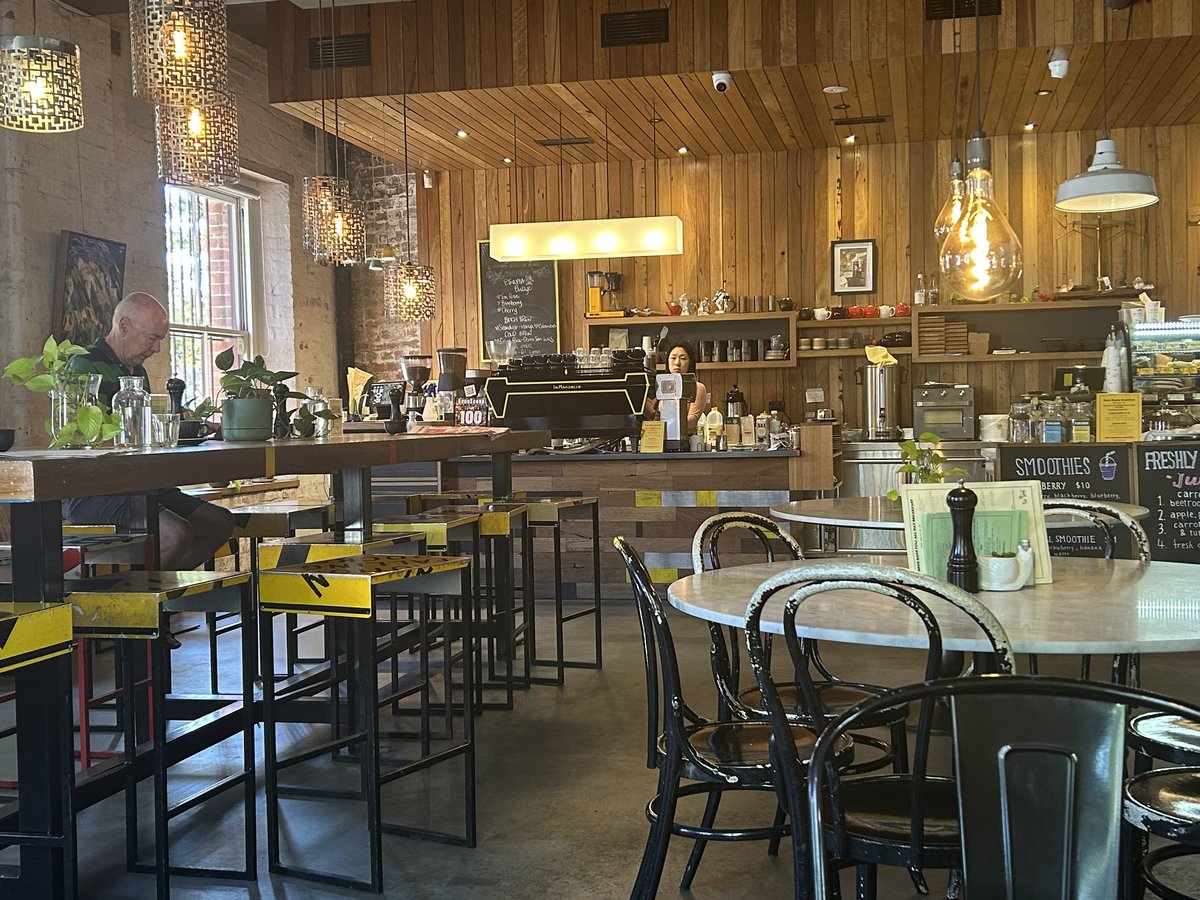 Black Gold coffee counter with hanging pendant lights and smoothie menu board