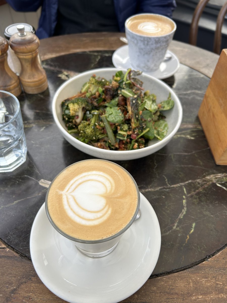 Broccoli salad with two heart latte art coffees on a marble table at A Thousand Blessing