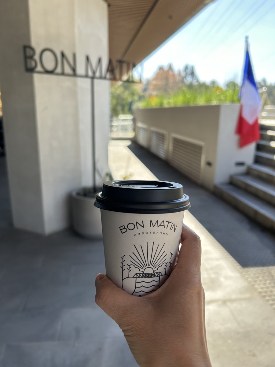 Bon Matin Abbotsford branded coffee cup with sunrise bridge logo and French flag