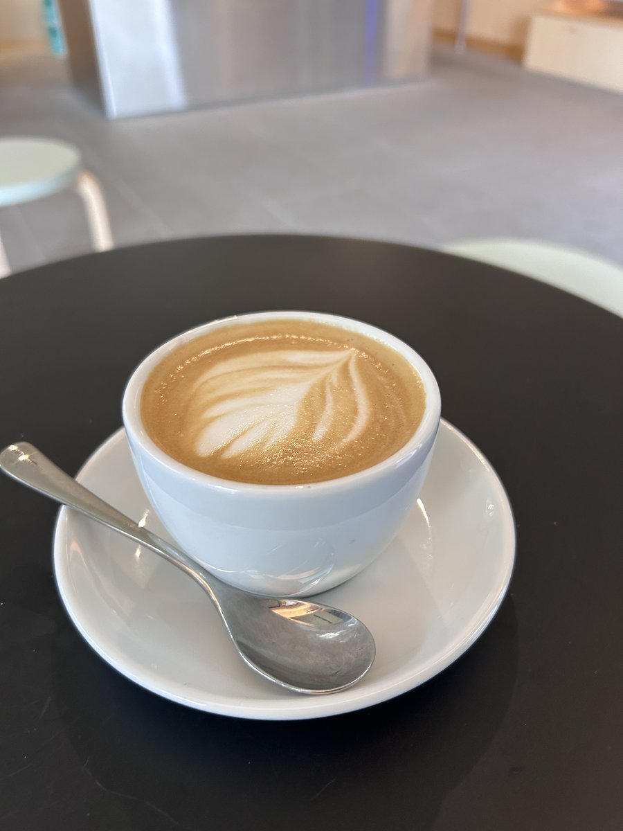 Latte with leaf-pattern art at The Commons