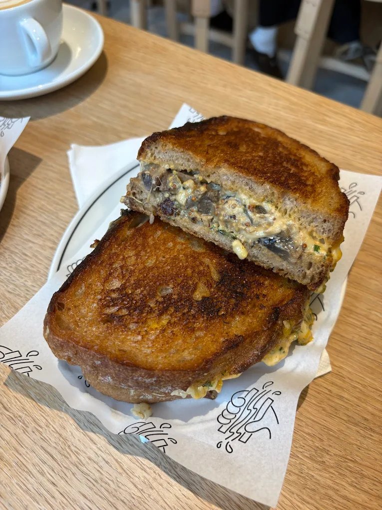 Toasted mushroom and cheese sandwich from Hector's Deli, cut in half