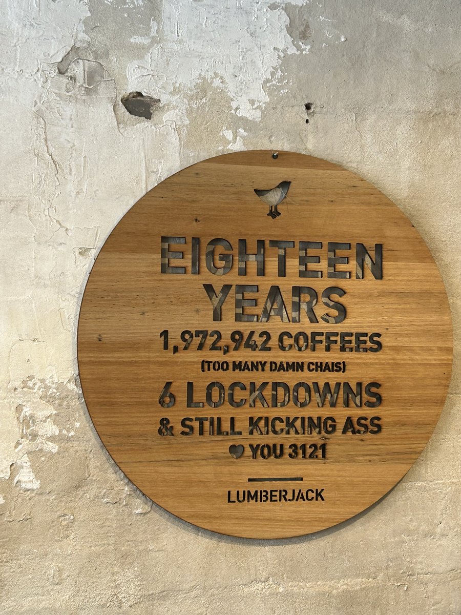Wooden sign at LumberJack celebrating eighteen years and 1,972,942 coffees served
