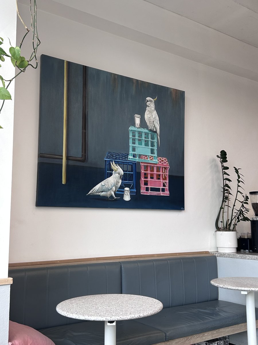 Maker café interior with cockatoo artwork on the wall