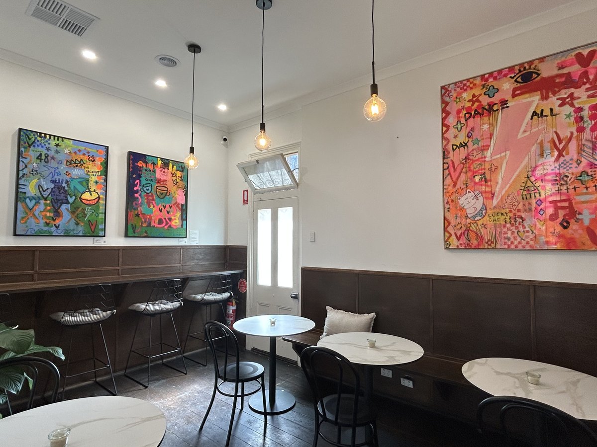 Mr. Dot Richmond interior with colourful pop-art paintings above bench seating