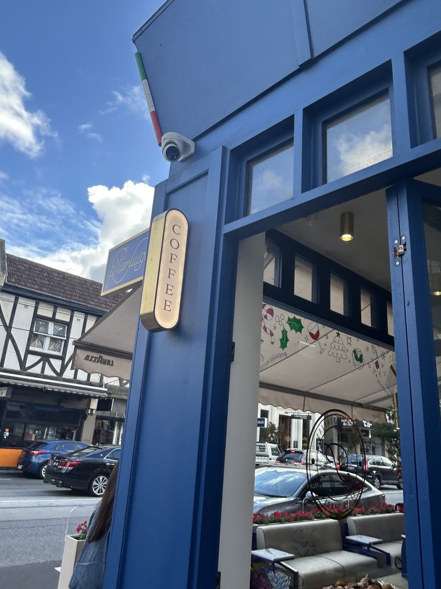 Pierluigi storefront with blue facade and coffee sign