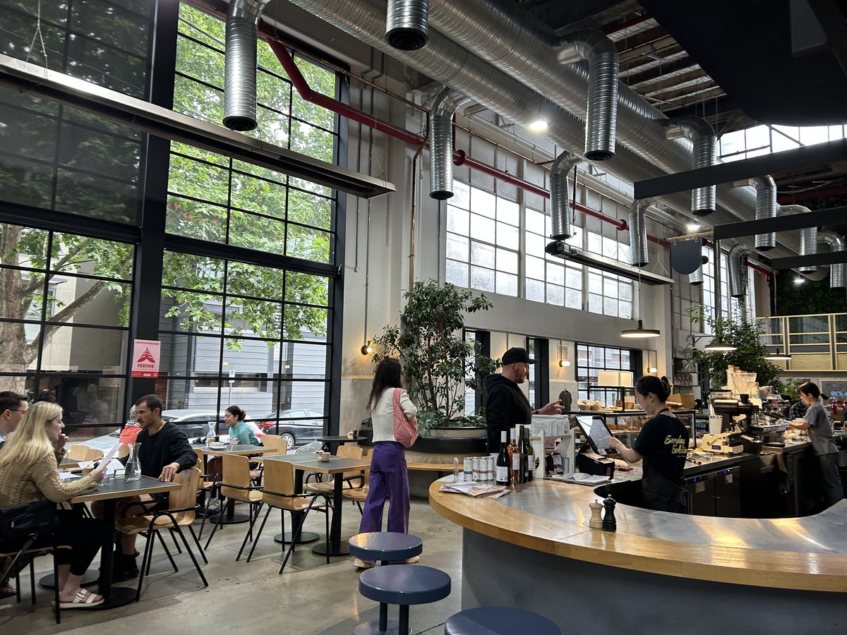 Veneziano Coffee Roasters dining area with warehouse windows
